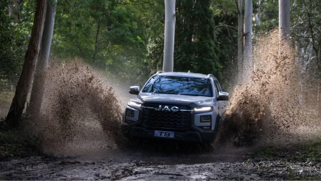 a jac t9 ute driving through muddy water