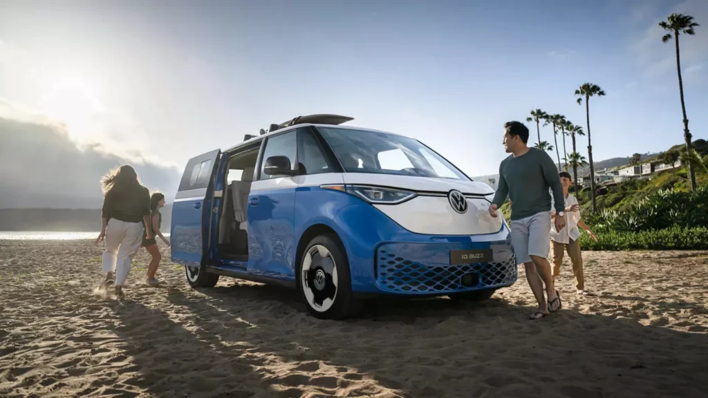 Volkswagen ID Buzz van with a vacationing family on the beach