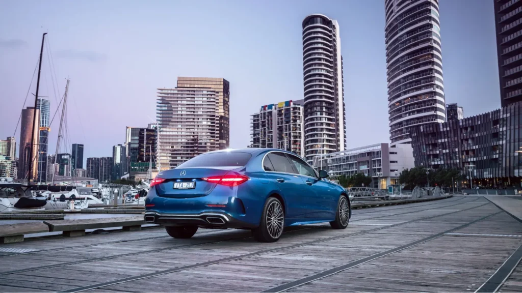 a classy Mercedes-Benz C-Class on a road in evening
