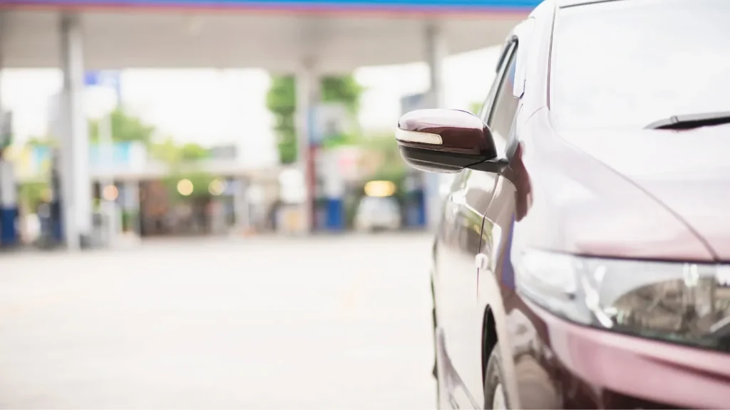 A car driving away from a fuel station