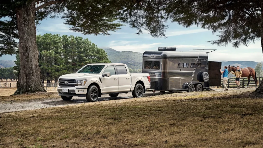 Ford f150 ute towing a trailer carrying  a horse