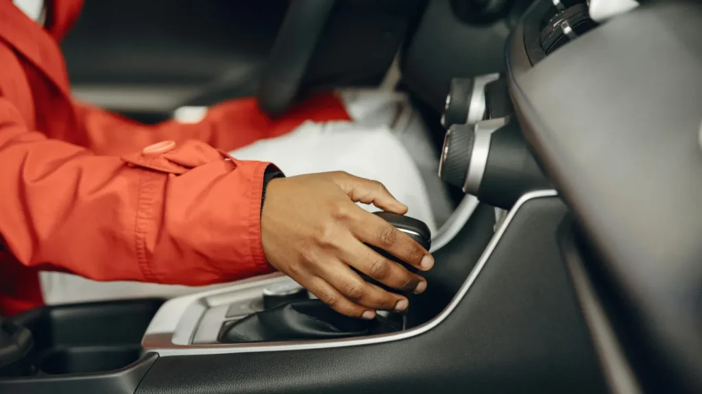 a woman shifting gear in an automatic hybrid car