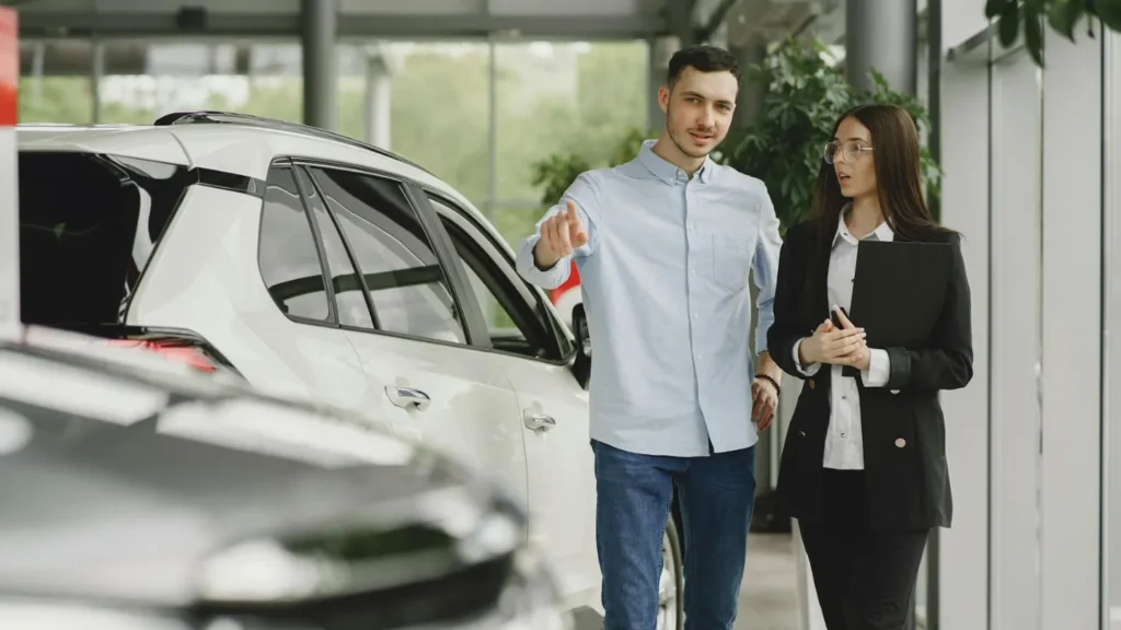A customer asking questions about a car at the dealership