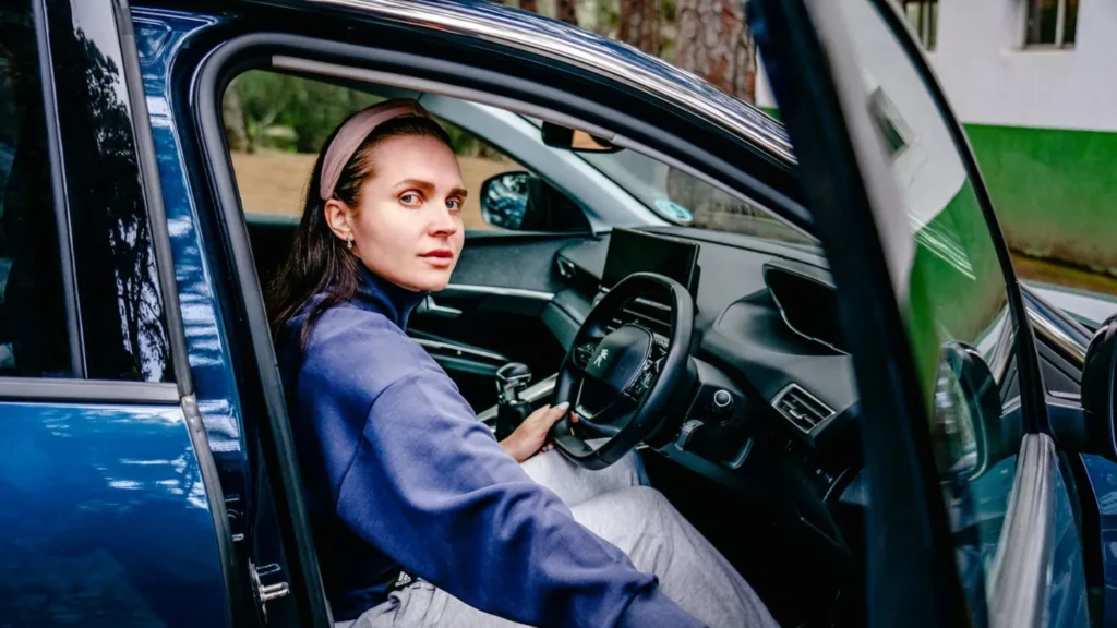 A woman in the car driver seat