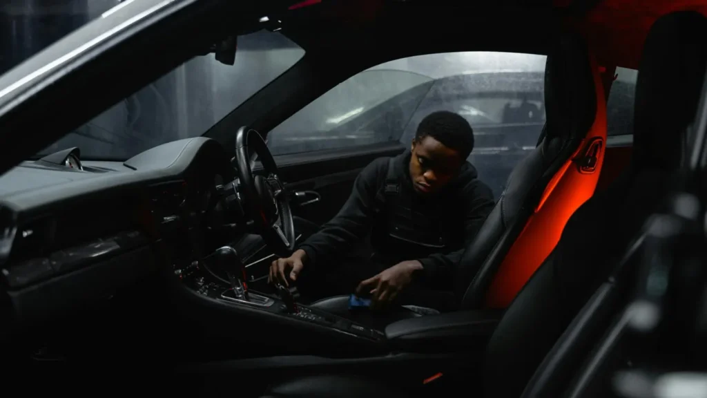 man installing a brake controller under the car dashboard