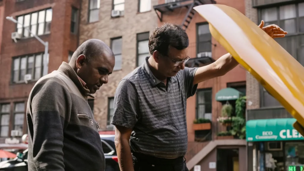 two men looking under the cars bonnet