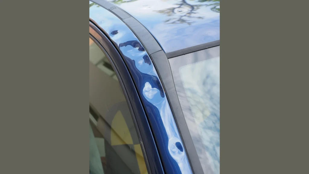 Hail damage on a car a pillar