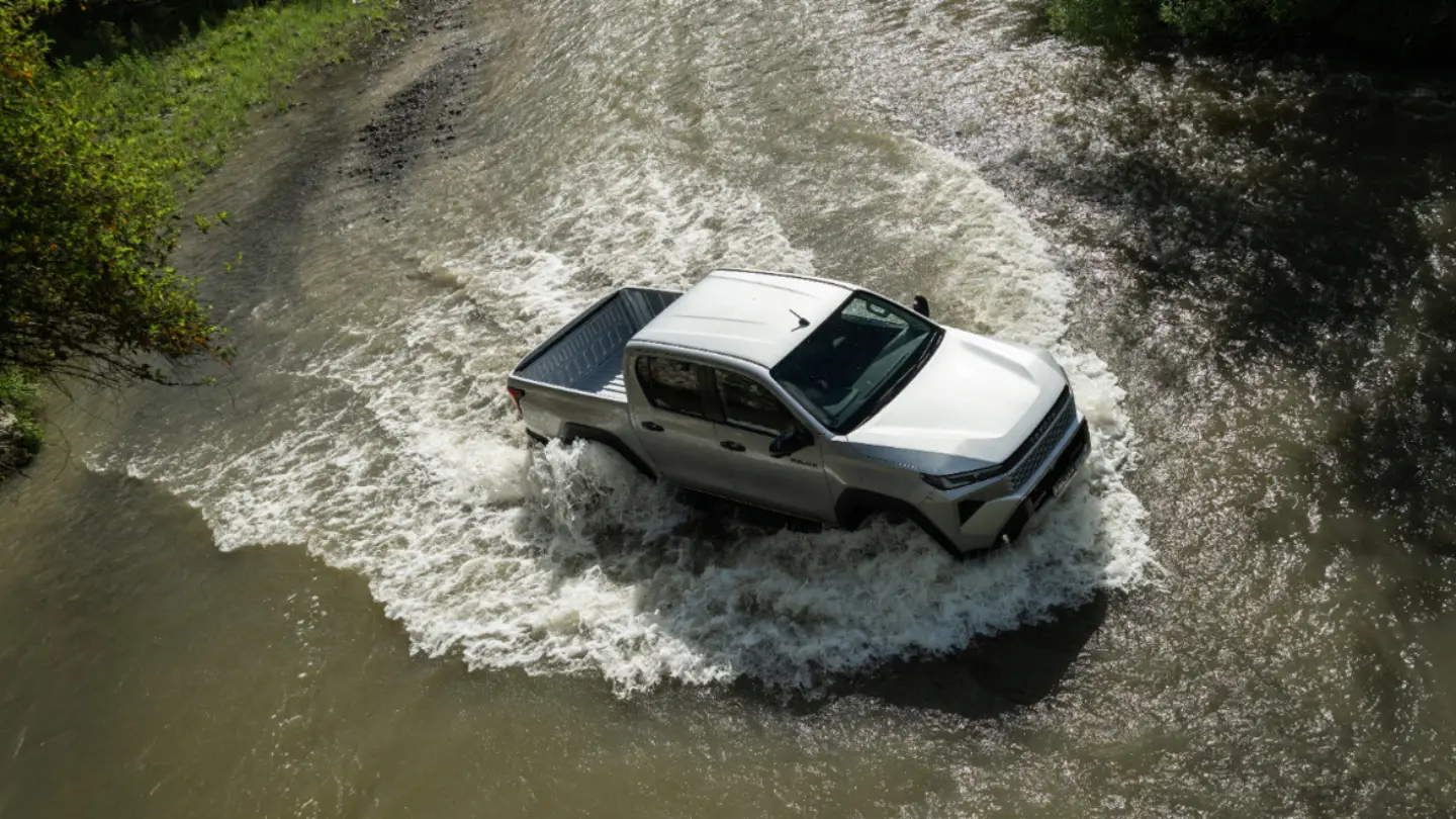 Toyota Hilux ute crossing a stream
